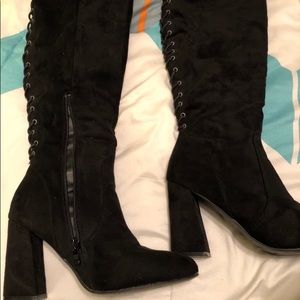 Over the knee lace back boots.